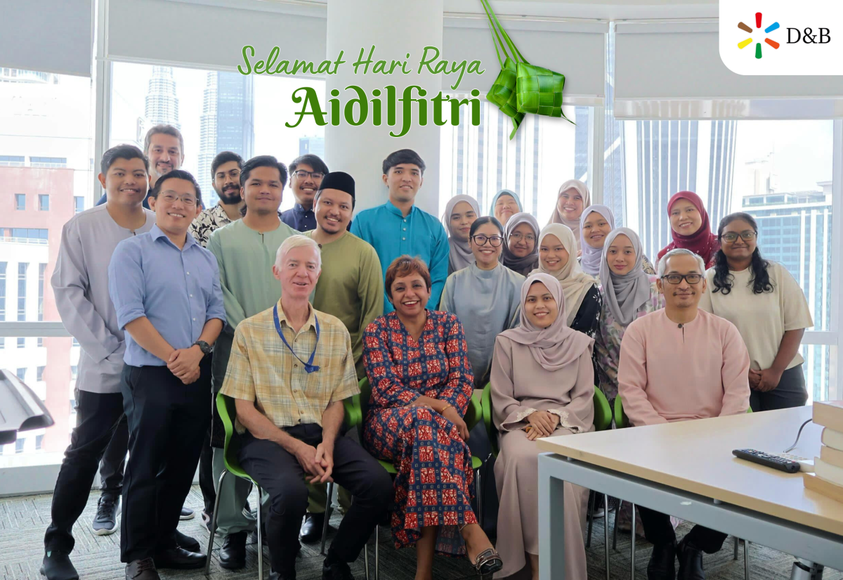Team group picture of D&B Malaysia Office, Selamat Hari Raya Aidilfitri with Kuala Lumpur skyline background