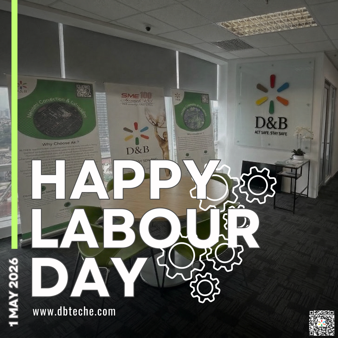 An office interior with "HAPPY LABOUR DAY" text overlaid. The D&B company logo is visible on the wall. Banners with company information are displayed behind a table.